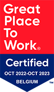 Un badge rectangulaire divisé en deux parties : en haut, texte blanc 'Great Place To Work' sur fond rouge ; en bas, texte blanc 'Certified OCT 2022-OCT 2023 BELGIUM' sur fond bleu.