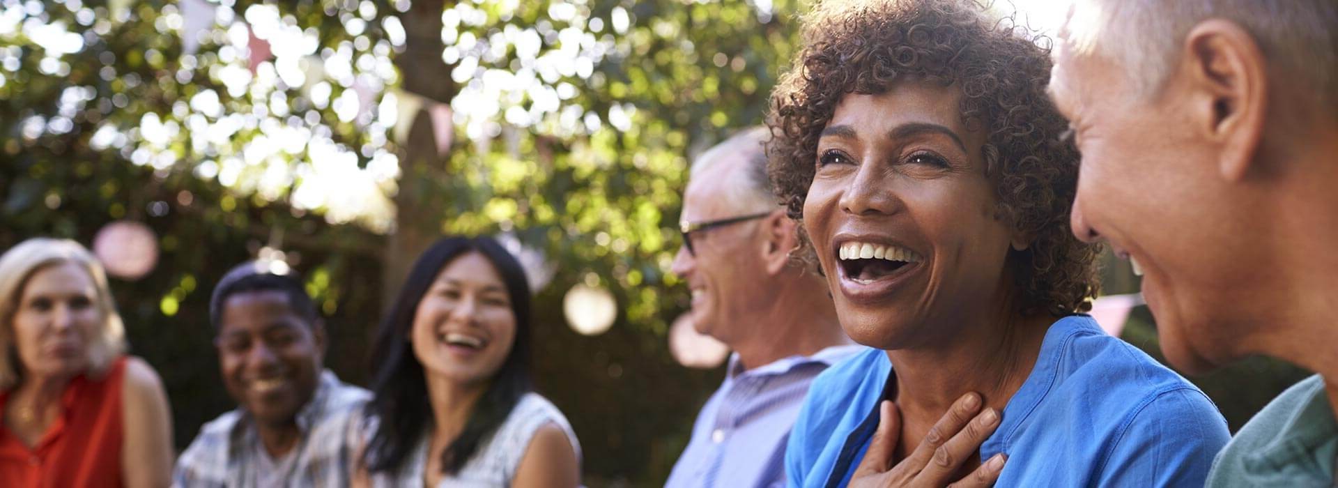 Bild zeigt ein Paar im Hörcenter mit einem Hörakustiker, der Hörgeräte vorführt.
