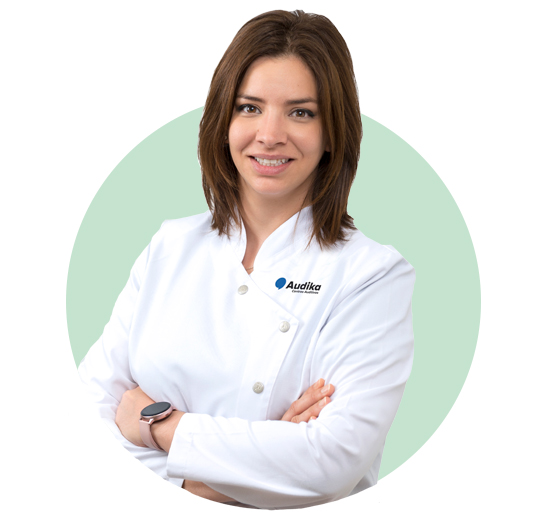 La imagen muestra un audioprotesista frente a un fondo verde