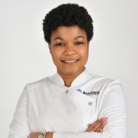 audioprotesista profesional de Audika con uniforme blanco