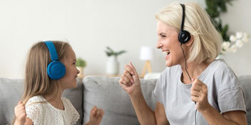 Une grand-mère et sa petite fille écoute de la musique