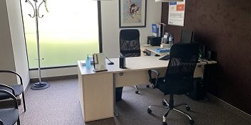 Cabine d’audioprothésiste moderne dans le centre auditif Audika à Castelnau, avec bureau, chaises et équipement professionnel.