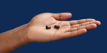 Appareils auditifs miniatures dans la paume de la main