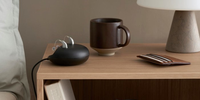 appareil auditif rechargeable à côté d'un lit