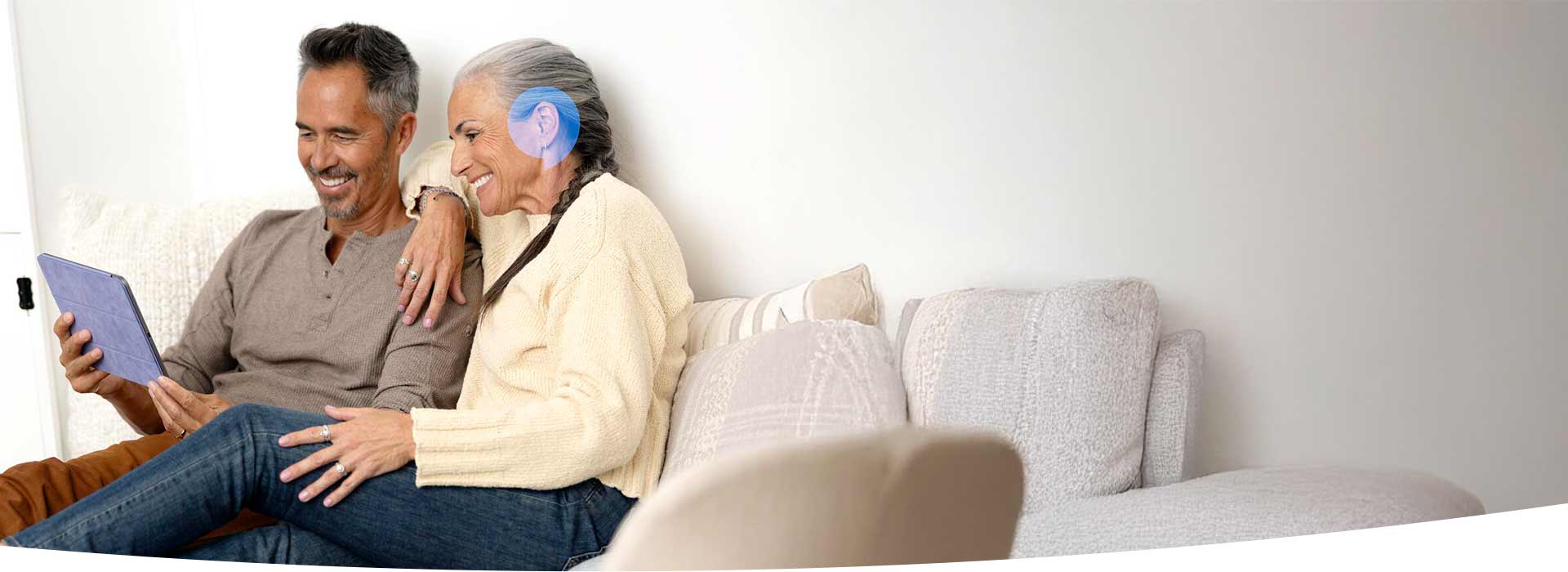 Image shows man in front pf laptop with headphone on