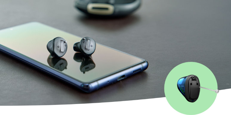 Wypróbuj aparaty słuchowe Oticon Own™ w gabinecie.