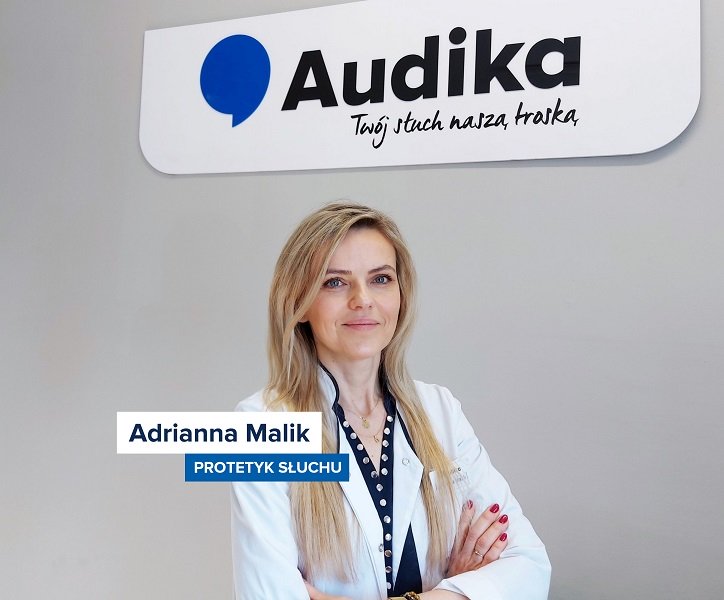 Protetyk słuchu Adrianna Malik na tle logo Audika i hasła „Twój słuch naszą troską”.
