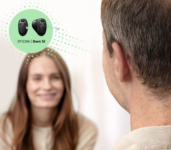 Man som har en Oticon Own Si hörapparat som sitter i örat
