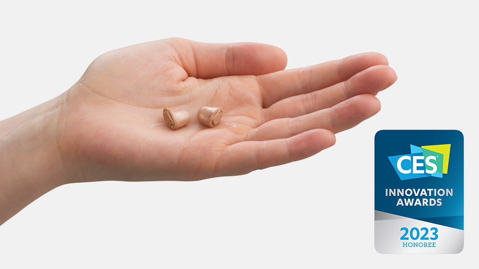 Oticon Own in-the-ear hearing aids showcased next to the CES 2023 Innovation Awards badge.