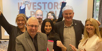 Audika team celebrating achievement at an Investors in People event.