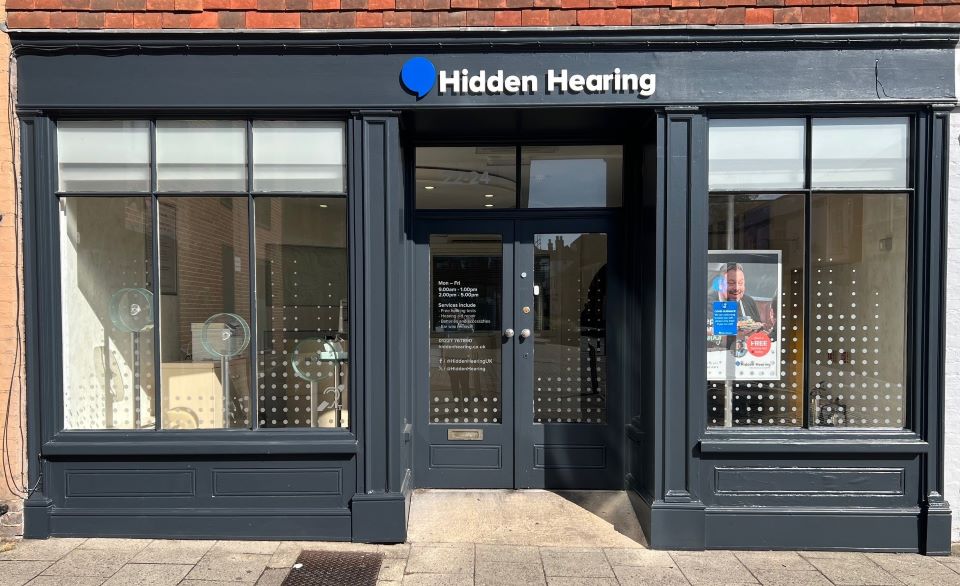 Canterbury Audika branch exterior with dark gray facade, large glass windows, and visible signage.
