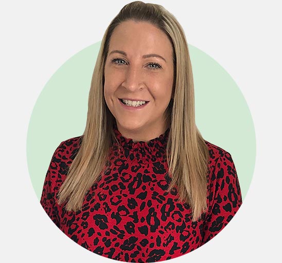 Audika audiologist Jen Canham wearing a red leopard print top