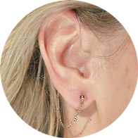 Gold Figaro chain accessory for hearing aid users, designed for both functionality and style.
