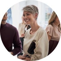 Woman in a social setting wearing digital hearing aids.