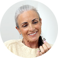 Senior woman holding a discreet hearing aid