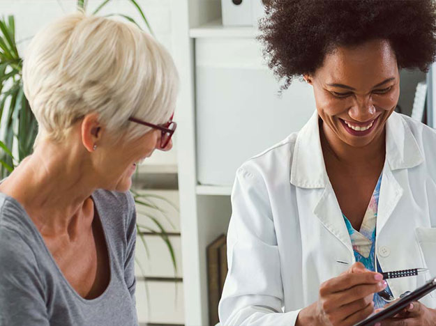 Woman consulting a doctor in a medical office setting.