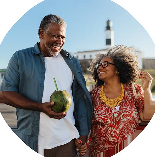 A man and woman with hearing loss smile and laugh