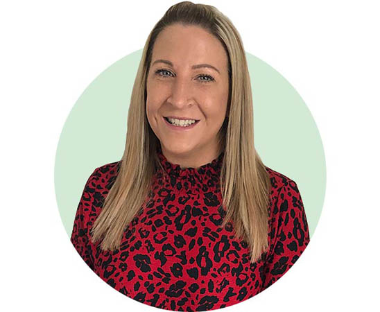 Audika audiologist Jen Canham in a red leopard-print blouse
