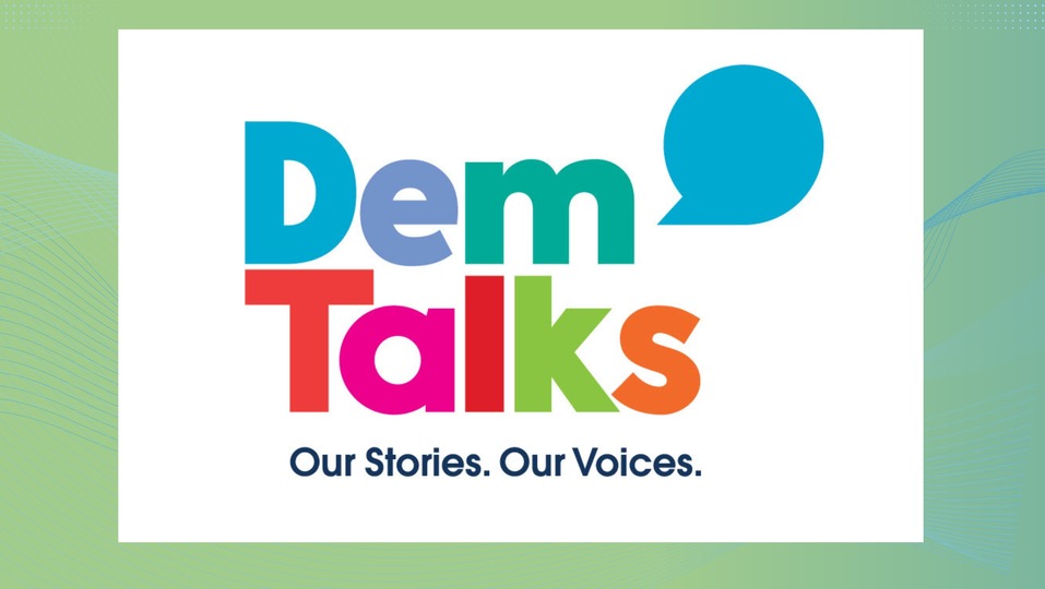 The design features the bold, colorful text 'Dem Talks,' styled in blue, green, pink, red, and orange, accompanied by a blue speech bubble. Below, the tagline reads, 'Our Stories. Our Voices.' The white background is framed by a light green gradient with subtle wave patterns.