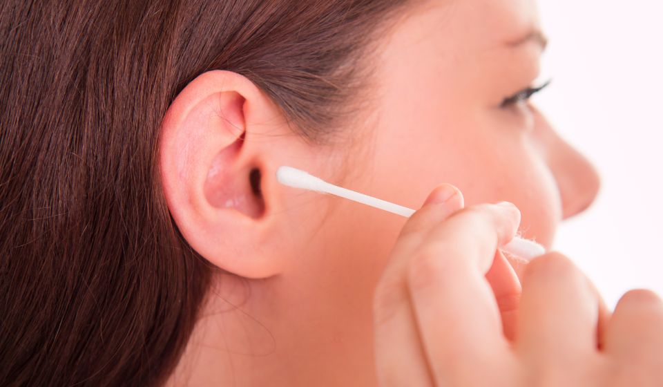 cleaning ear with cotton swab