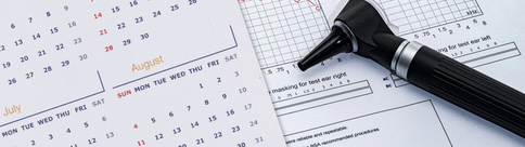 [GEN] A medical otoscope lies on top of hearing test result forms, adjacent to a calendar spanning July and August, symbolizing hearing clinic appointments and audiologist consultations for hearing care.