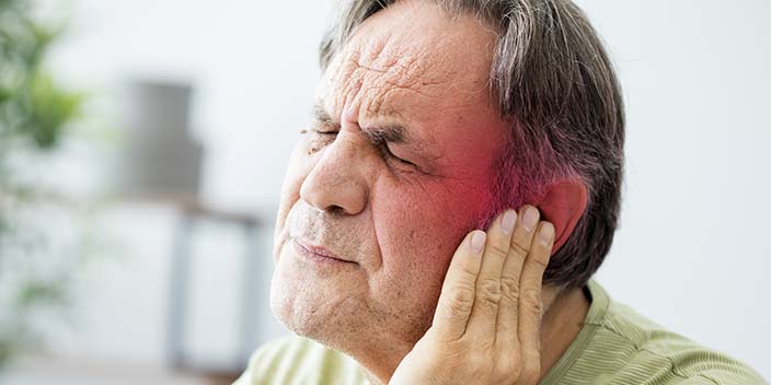 man experiencing ear discomfort
