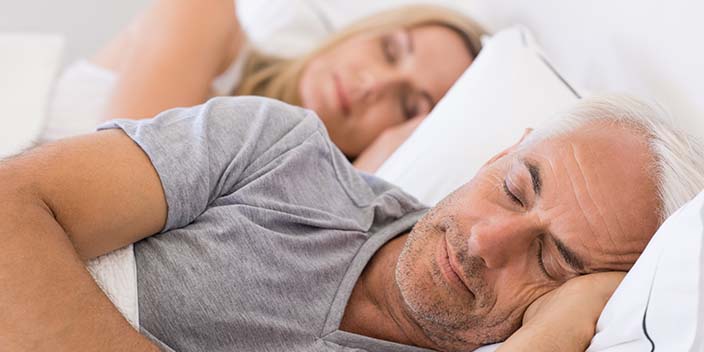 [GEN] A man and a woman lie side by side in bed, appearing peaceful and asleep. The image focuses on their relaxed posture in a serene bedroom setting. No text is visible.