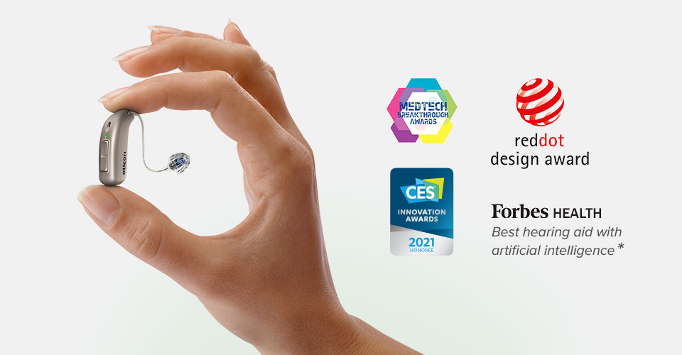 Oticon More hearing aid held between fingers, showcasing award logos for innovation, design, and AI technology optimization.