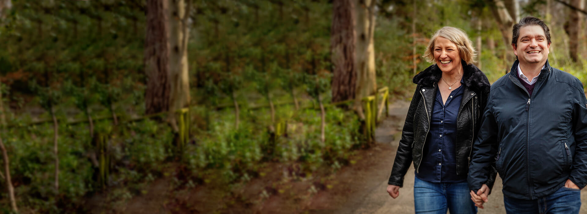 Low frequency hearing loss man and woman walking in forrest