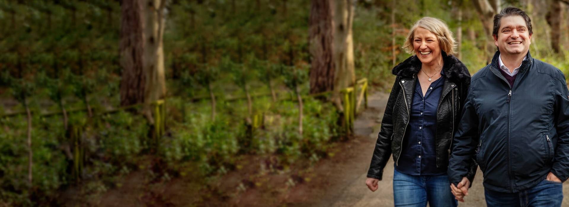 Low frequency hearing loss man and woman walking in forrest