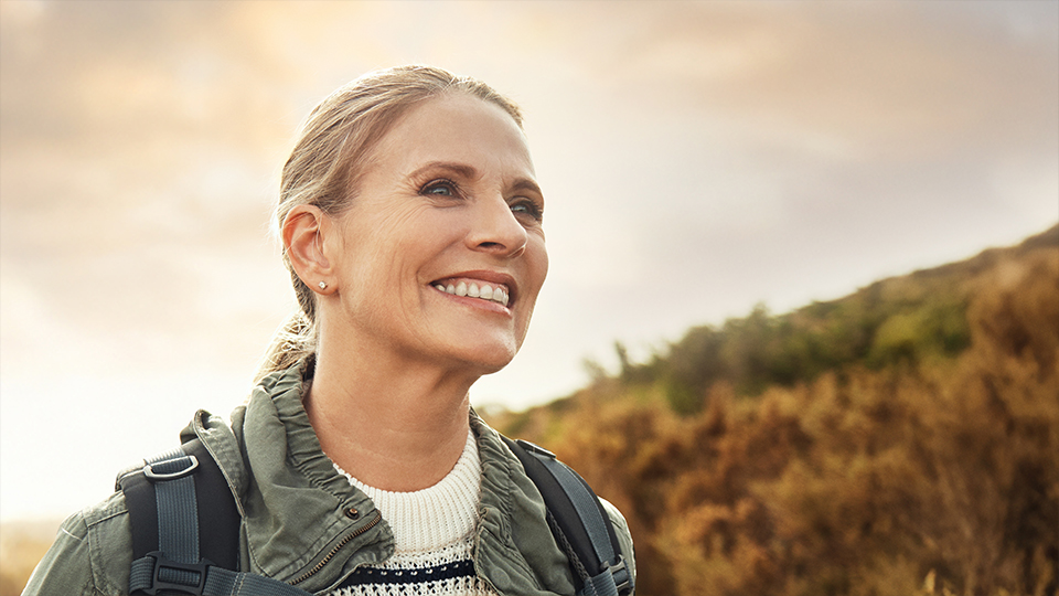 Happy hiker smiling while enjoying the outdoors