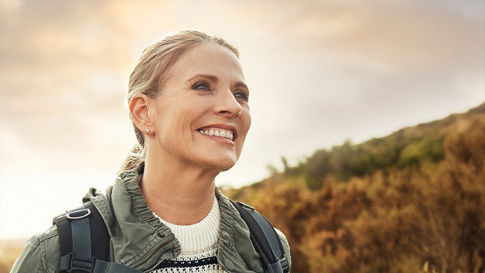 Happy hiker smiling while enjoying the outdoors
