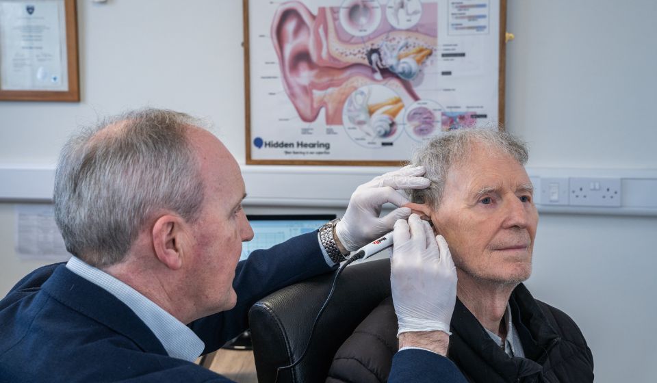 Audiologist conducting an inner ear examination with a video otoscope