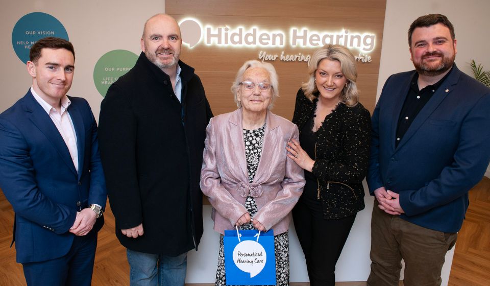 Gift Of Hearing winner Peggy Hopkins standing with local audiologists at Hidden Hearing office.