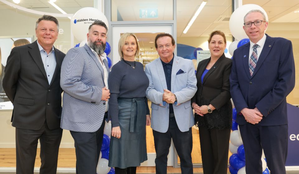 Group of people posing for a picture while standing outside the Hidden Hearing clinic in Portlaoise shopping centre