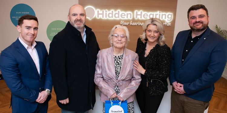 Gift Of Hearing Winner Peggy Hopkins smiling with expert local audiologists