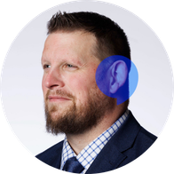 A photograph of Hidden Hearing audiologist Jim Noone smiling with a speech bubble overlayed on his ear