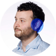 A photograph of Hidden Hearing audiologist Joe Viney smiling with a blue speech bubble overlayed on his ear