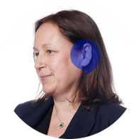 A photograph of Hidden Hearing audiologist Karen McComiskey smiling with a blue speech bubble overlayed on her ear
