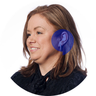 A picture of Hidden Hearing clinic coordinator Lorraine O'Grady smiling with a blue speech bubble overlayed on her ear