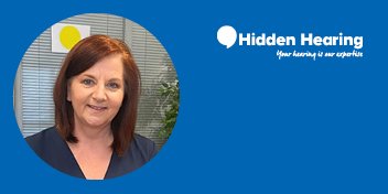 A professional portrait features a blurred-faced individual with straight, shoulder-length auburn hair, set against an office backdrop with blinds and greenery. The blue frame includes the Hidden Hearing logo with text: 'Your hearing is our expertise.'