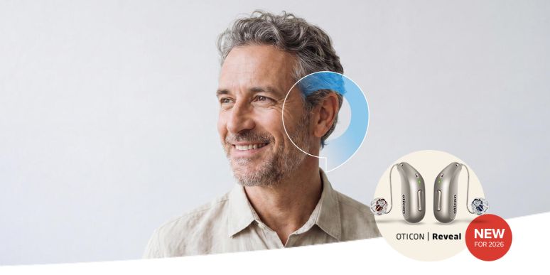A man smiling with a blue speech bubble overlayed on his ear with a graphic beside him of the new for 2026 state-of-the-art Oticon Reveal hearing aid
