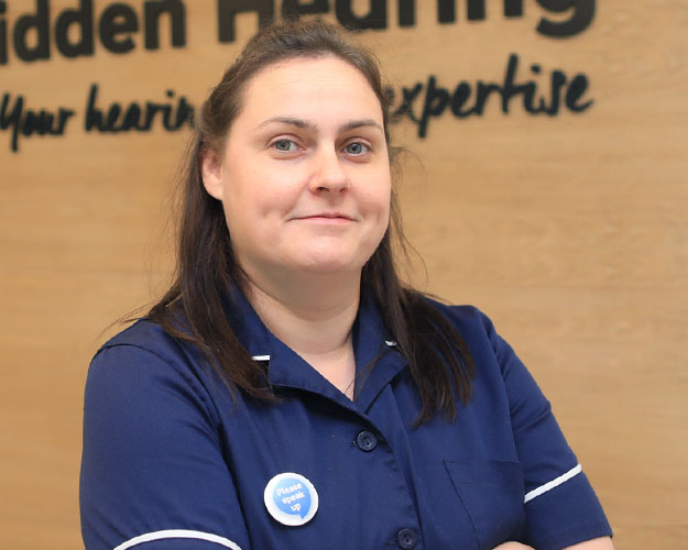 audiologist in professional uniform at a hearing care clinic