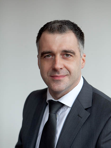 man in a gray suit and black tie