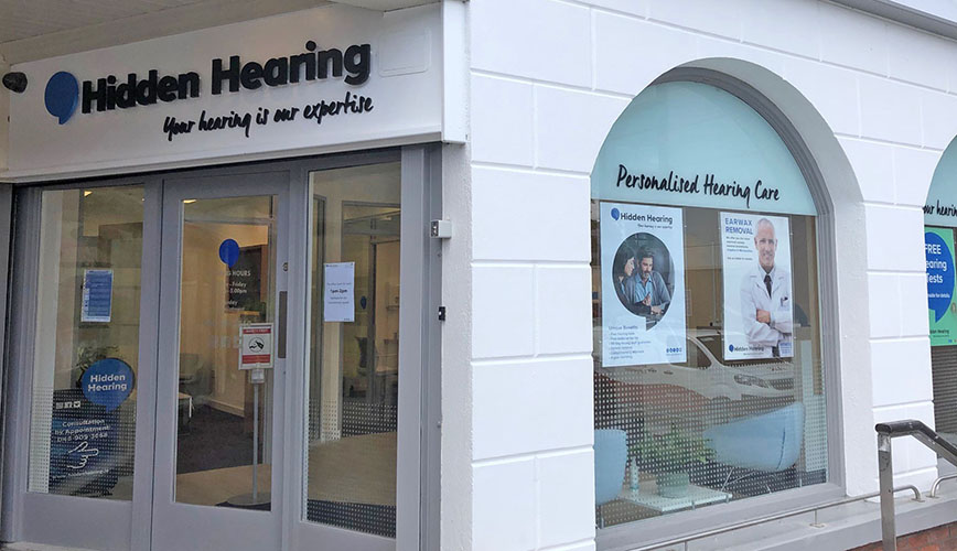 Hidden Hearing Navan clinic exterior showcasing personalised hearing care posters and branding.