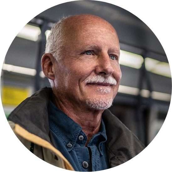 Man smiling while on public transport