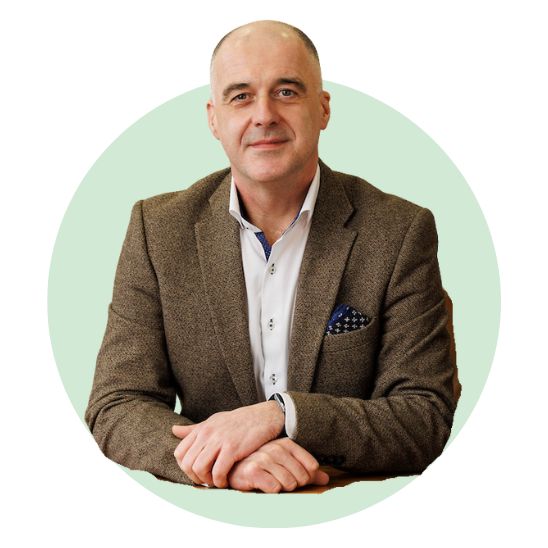 male audiologist sitting with hands folded