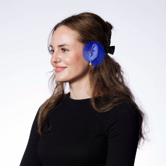 Audiologist Johane wearing a black top with long hair tied back and a focus on hearing care expertise.