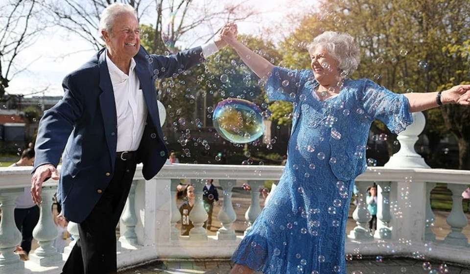 man and woman dancing with bubbles