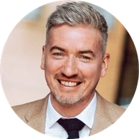 A photograph of local clinic coordinator Christy O'Donnell smiling in a suit